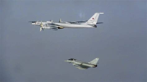 Royal Air Force ground crew preparing an RAF Typhoon fighter jet. It is night-time and the team are
