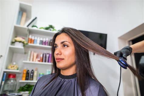 Hairdresser using a hair straightened to straighten the hair hair ...