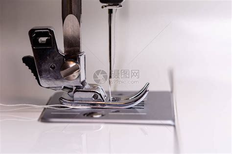 缝纫机针快速上下移动的特写。在缝纫车间里，一位裁缝正在缝制一种浅色的织物。视频素材_ID:VCG42N1281834027-VCG.COM