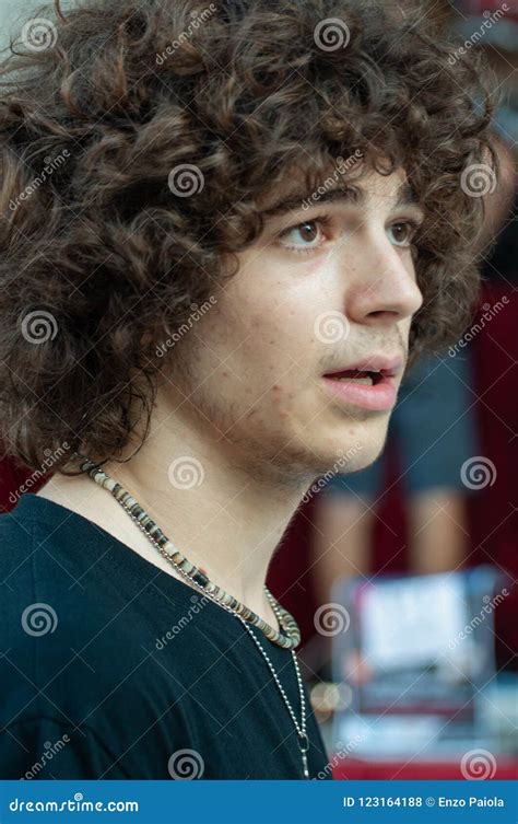 Young Handsome Guy Posing in Black T-shirt, Brown with Curly Hair Stock ...