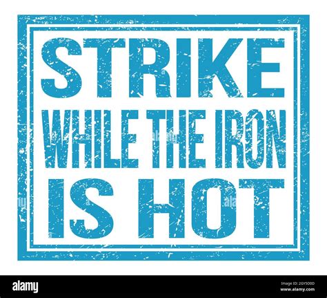 STRIKE WHILE THE IRON IS HOT, written on blue grungy stamp sign Stock ...