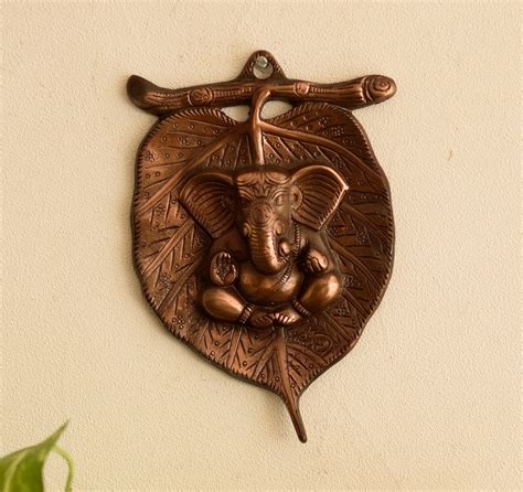 Metal wall hanging of Lord Ganesha on Leaf - eCraftIndia Online