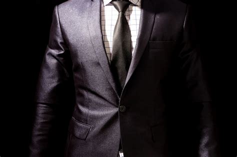 Businessman with black suit on black background | Premium Photo
