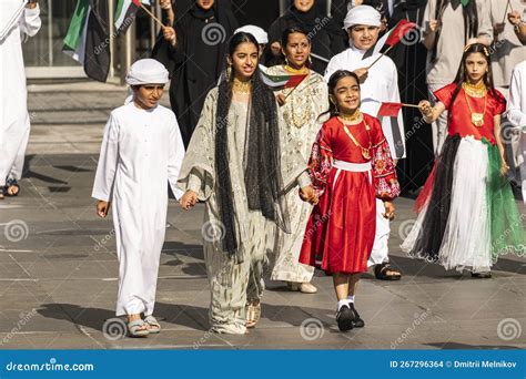 Children in Traditional Clothes Wave Flags of the United Arab Emirates ...