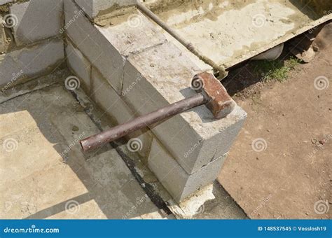 The Iron Hammer Lies on the Cinder Block on the Background of the Pan ...