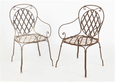 Lot - A pair of wrought iron outdoor chairs
