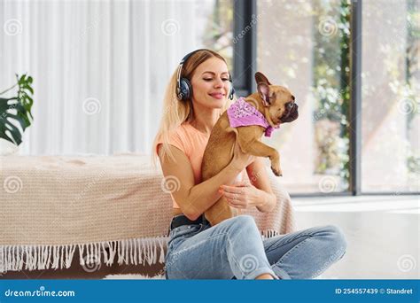 Sitting on the Floor. Woman with Pug Dog is at Home at Daytime Stock ...