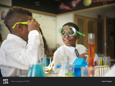 Children wearing goggles in science class stock photo - OFFSET