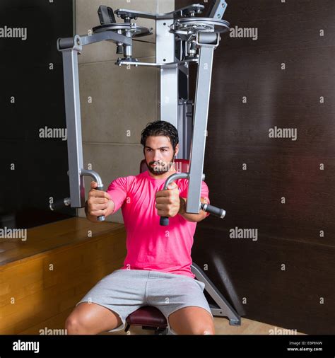 pec-deck fly flies pec deck chest workout man exercise at gym Stock ...