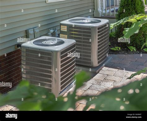 Outdoor air conditioners/heaters in back of housing complex Stock Photo ...