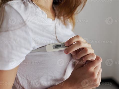 woman checking armpit temperature close-up 22069675 Stock Photo at Vecteezy