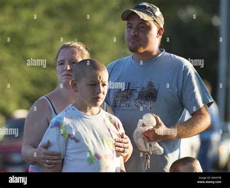 Trisha Stump, Matthew Fajardo (C) and Jason Grice visit a memorial at ...