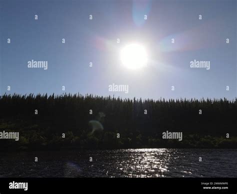 Open skies and the sun shining bright on a summer day. Green trees and fresh blue waters. The ...