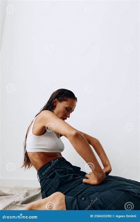 Woman Poses Sitting on Her Knees on the Floor with Beautiful Tanned ...