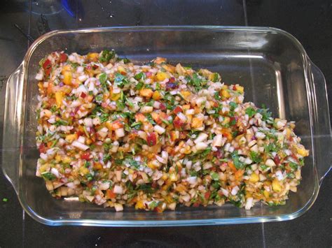 Close-up on salmon fillet with fruit salsa, over rice.