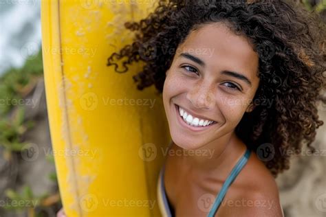 AI generated Biracial woman smiling holding surfboard, energetic and ...