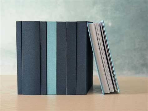 Set of books in row on wooden table | Premium Photo