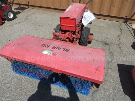 Gravely machine with sweeper attachment. Model 985006 | GovDeals