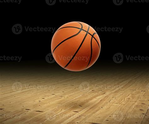 A basketball with a dark background on a hardwood gym floor 25851989 ...