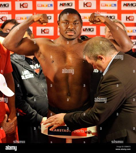 Nigerian heavyweight boxer Samuel Peter poses on the scales at the ...
