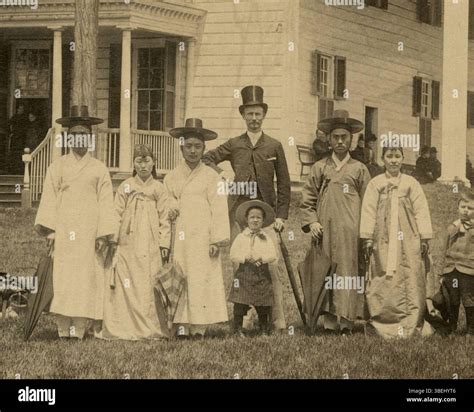 This 1889 photograph by Luke C. Dillon captures the Korean ambassadors and their wives posing ...