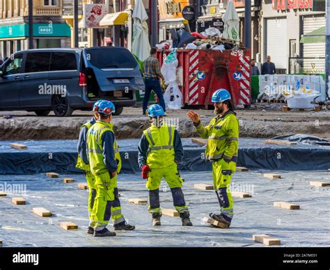 Road construction workers in yellow safety uniforms - Boulevard Anspach ...