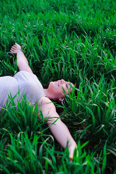 "Natural Spanish Woman Lying On The Grass" by Stocksy Contributor ...