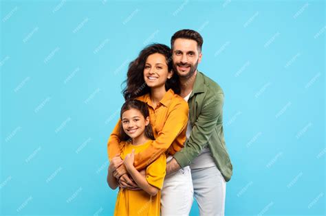 Premium Photo | Happy caucasian family of three with daughter embracing ...