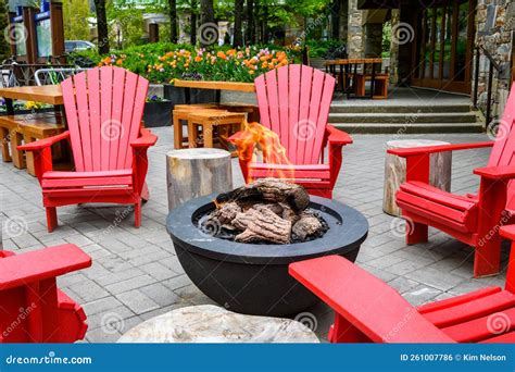 Bright Red Adirondack Chairs Around a Gas Fire Pit, Seating in an ...