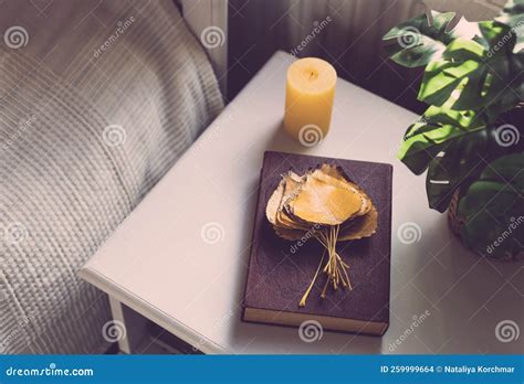 Book with Leaves and Candles on the Bedside Table. Stock Photo - Image ...