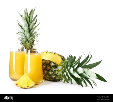 Cut pineapple and glasses with juice on white background Stock Photo ...