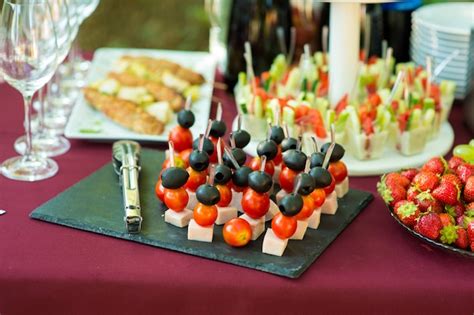 Cheese canapes on a skewer with olive and tomato | Premium Photo