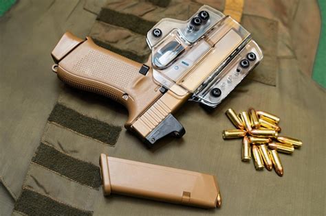 Tactical weapon sandcolored pistol in a transparent holster magazine ...