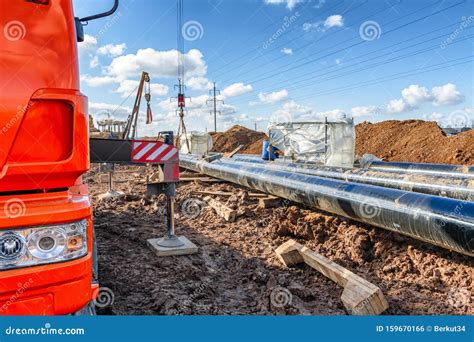 Construction Work on Pipe Laying of Pipeline into the Trench Using a ...