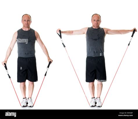Lateral raise exercise with resistance band. Studio shot over white ...