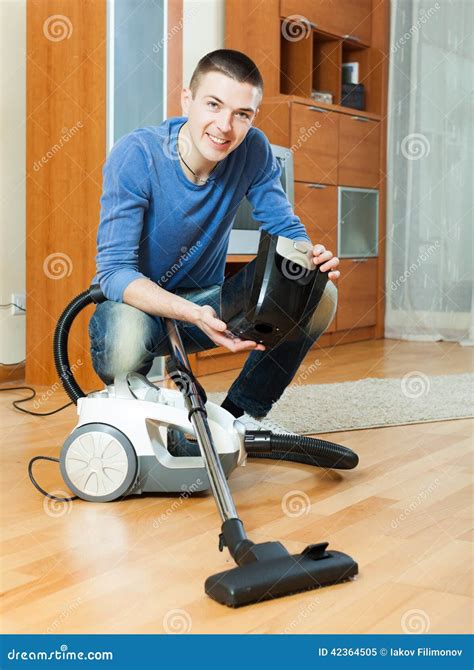 Guy Vacuuming with Vacuum Cleaner on Parquet Floor in Living Room Stock ...