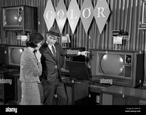 1960s COUPLE SHOPPING FOR COLOR TVS Stock Photo - Alamy