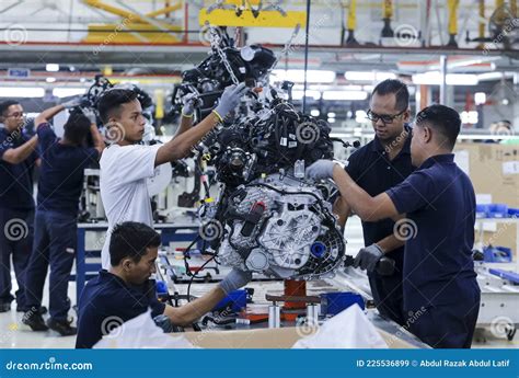 Workers Assembles Cars at Automobile Assembly Line Production Plant ...
