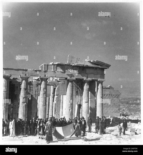 The Greek Prime Minister and party, led by flag-bearers, walk to the ...