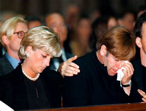 Britain's Diana, Princess of Wales, sits next to pop-star Elton John ...