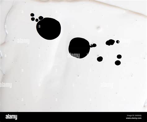 Spots of black paint on white paint Stock Photo - Alamy