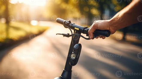 Closeup of a hand grasping the handlebars of an electric scooter, ready ...