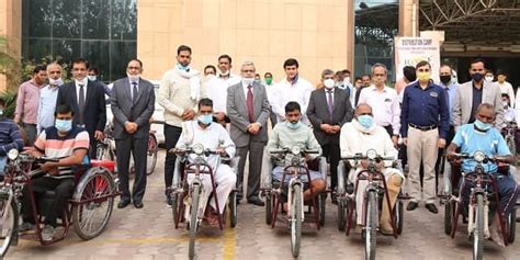 REMCL distributes motorised tricycles among divyangs