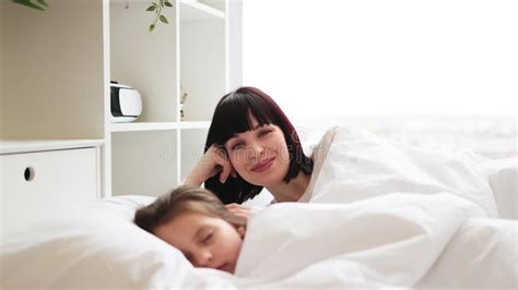 Mother and Child Resting in Bed with White Sheets Stock Video - Video ...