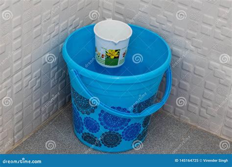 Blue Bucket with Mug in Bathroom Stock Image - Image of liquid, wash ...