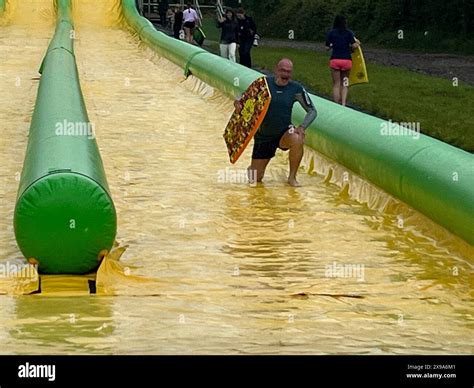 Leader of Liberal Democrats Sir Ed Davey after he rode down the Ultimate Slip n Slide attraction ...