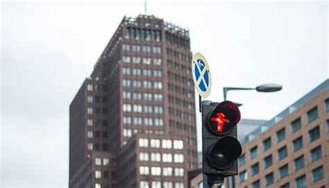 Low angle view of road sign against buildings | Premium Photo