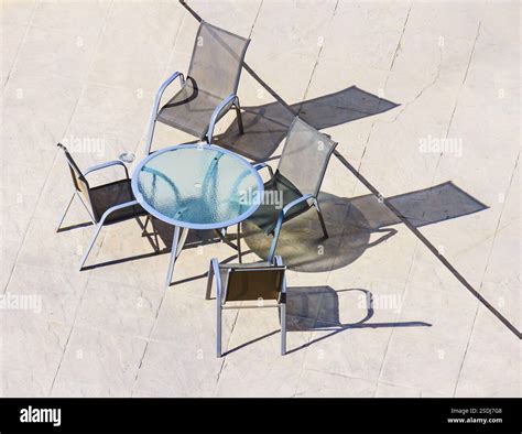Shadow on the floor from a transparent glass table with chairs Stock ...