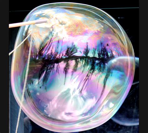 The front surface of a bubble reflects surroundings, while the back ...