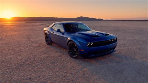 Download Sunset Behind A Blue Dodge Challenger Wallpaper | Wallpapers.com